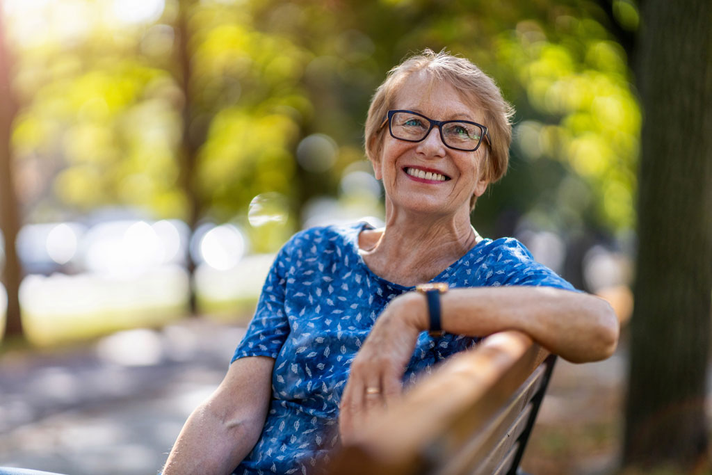 prairie lake seniors community senior sitting on courtyard bench